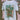 A white t-shirt with illustration of racing vehicles. 